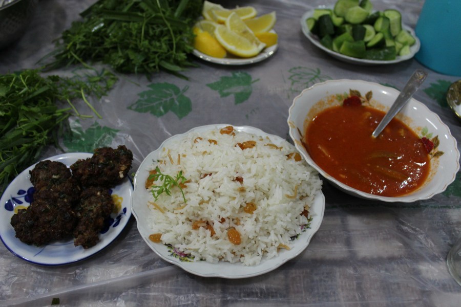Dinner: shufte (meatballs), brinj (rice), shillay bazam (okra soup), and garnish (anise, parsley, lemon, and cucumber).