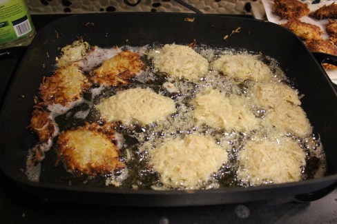 Frying the latkes.