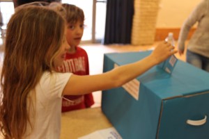 11-year old Hodaya, putting her mother's ballot in the box. 